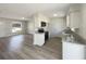 Bright kitchen features stainless steel appliances, granite counters and gray wood-look flooring at 472 Little Aspen Ct, Ocoee, FL 34761