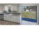Kitchen with stainless dishwasher, granite counters and sliding glass door to the back yard at 472 Little Aspen Ct, Ocoee, FL 34761