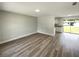 Open living room with modern flooring, neutral paint, and access to the kitchen at 472 Little Aspen Ct, Ocoee, FL 34761