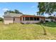Exterior view of home, highlighting the large backyard and screened-in porch at 4930 Gifford Blvd, Orlando, FL 32821