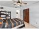 Comfortable bedroom with a ceiling fan, closet, and tiled floors with decorative model displays at 4930 Gifford Blvd, Orlando, FL 32821