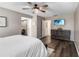 This main bedroom features wood-look flooring and access to an ensuite bathroom at 4930 Gifford Blvd, Orlando, FL 32821