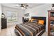 Bright bedroom with tiled flooring, a ceiling fan, and large window providing ample natural light at 4930 Gifford Blvd, Orlando, FL 32821