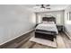 Spacious primary bedroom with wood-look flooring, a ceiling fan and natural light at 4930 Gifford Blvd, Orlando, FL 32821