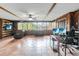 Versatile bonus room with wood paneled walls, tile flooring, ceiling fan, and natural light at 4930 Gifford Blvd, Orlando, FL 32821