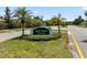 Entrance to the Green Briar Village community with lush landscaping and mature palm trees at 4930 Gifford Blvd, Orlando, FL 32821