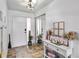 Welcoming foyer with tiled floor, closet with mirrored doors, and ample natural light at 4930 Gifford Blvd, Orlando, FL 32821