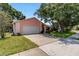 Attractive single-story home with a spacious driveway, lush lawn, and mature trees for shade at 4930 Gifford Blvd, Orlando, FL 32821