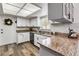 Beautiful kitchen features granite counters, stainless steel appliances and white cabinets at 4930 Gifford Blvd, Orlando, FL 32821