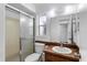 Bathroom featuring a sliding glass shower door, toilet, vanity, and large mirror at 611 Lakespur Ln, Altamonte Springs, FL 32714