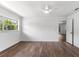 Bright bedroom features dark wood floors, a ceiling fan, and a large window with lots of natural light at 611 Lakespur Ln, Altamonte Springs, FL 32714