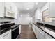Remodeled kitchen features granite countertops, modern appliances, and wood floors at 611 Lakespur Ln, Altamonte Springs, FL 32714