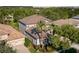 Aerial view of a large home with a brown tile roof, mature landscaping, and surrounding trees at 7536 Green Mountain Way, Winter Garden, FL 34787