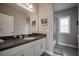 Bathroom featuring white vanity with granite countertops, and walk-in shower with glass doors at 7536 Green Mountain Way, Winter Garden, FL 34787