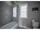 Bathroom featuring tiled shower and glass door, as well as a large window at 7536 Green Mountain Way, Winter Garden, FL 34787