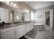 Stylish bathroom featuring dual sinks, granite countertops, a soaking tub, and a separate shower at 7536 Green Mountain Way, Winter Garden, FL 34787