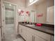 Bathroom with gray countertops, white cabinets, and shower/tub combination with glass door at 7536 Green Mountain Way, Winter Garden, FL 34787