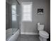 Bathroom featuring tiled shower and glass door, as well as a large window at 7536 Green Mountain Way, Winter Garden, FL 34787