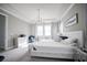 Bright and airy primary bedroom with a white tufted bed frame, tray ceilings, and elegant chandelier at 7536 Green Mountain Way, Winter Garden, FL 34787