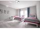 A well-lit room with three twin beds, decorated with Mickey Mouse themed pictures at 7536 Green Mountain Way, Winter Garden, FL 34787