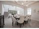 Bright dining room featuring an elegant dining set and decorative lighting fixtures at 7536 Green Mountain Way, Winter Garden, FL 34787