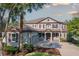 Elegant two-story home with a well-manicured lawn and charming curb appeal with its symmetrical windows and neutral paint scheme at 7536 Green Mountain Way, Winter Garden, FL 34787