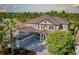 Elevated perspective of this home with a neatly designed landscape, ample parking, and a backdrop of verdant trees at 7536 Green Mountain Way, Winter Garden, FL 34787