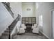 Stately foyer with a high ceiling, staircase, and seating area, enhanced by a fireplace, providing a stylish welcome at 7536 Green Mountain Way, Winter Garden, FL 34787