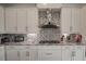 Granite countertops, tiled backsplash, and ample cabinet space highlight this well-equipped kitchen at 7536 Green Mountain Way, Winter Garden, FL 34787