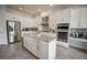 Spacious kitchen featuring white cabinets, granite countertops, stainless steel appliances, and tiled backsplash at 7536 Green Mountain Way, Winter Garden, FL 34787