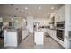 Spacious kitchen featuring white cabinets, granite counters, stainless steel appliances and a center island at 7536 Green Mountain Way, Winter Garden, FL 34787