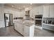 Bright eat-in kitchen with white cabinets, granite countertops, stainless steel appliances, and center island at 7536 Green Mountain Way, Winter Garden, FL 34787