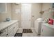 Functional laundry room equipped with washer, dryer, sink and storage at 7536 Green Mountain Way, Winter Garden, FL 34787