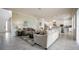 Open-concept living area with neutral decor, seamlessly connected to the kitchen and dining space at 7536 Green Mountain Way, Winter Garden, FL 34787