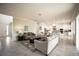 Cozy living room with comfortable seating and a modern kitchen, perfect for relaxation and culinary enjoyment in a stylish space at 7536 Green Mountain Way, Winter Garden, FL 34787