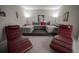 Home theater room featuring plush seating, a tiered platform, and movie-themed decor at 7536 Green Mountain Way, Winter Garden, FL 34787