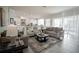 Open concept living space with plush sofas and chairs, flowing into a modern kitchen, ideal for entertaining and relaxation at 7536 Green Mountain Way, Winter Garden, FL 34787