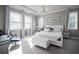 Beautiful main bedroom featuring a luxurious bed, ample natural light, and a cozy seating area at 7536 Green Mountain Way, Winter Garden, FL 34787