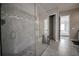 Modern bathroom showcasing a glass-enclosed shower with gray tiling and a decorative accent stripe at 7536 Green Mountain Way, Winter Garden, FL 34787