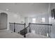 Upstairs landing area with an ornate staircase, decorative lighting, and a view to the lower level at 7536 Green Mountain Way, Winter Garden, FL 34787