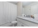 Bathroom with a single sink, a white cabinet, and a shower/tub with a white shower curtain at 8833 Cruden Bay Ct, Davenport, FL 33896