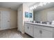 Bathroom featuring double sinks, light countertops, white cabinets, and a glass-enclosed shower at 8833 Cruden Bay Ct, Davenport, FL 33896