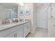 Bright bathroom featuring double sinks, modern fixtures, and a glass-enclosed walk-in shower at 8833 Cruden Bay Ct, Davenport, FL 33896