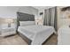 Comfortable bedroom featuring a tufted headboard, white linens and grey carpet at 8833 Cruden Bay Ct, Davenport, FL 33896