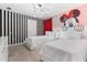 The bedroom features two twin beds, a striped accent wall, and a Minnie Mouse themed neon light fixture at 8833 Cruden Bay Ct, Davenport, FL 33896