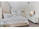 Well-lit bedroom featuring a tufted headboard bed and a modern dresser with television at 8833 Cruden Bay Ct, Davenport, FL 33896