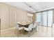 Formal dining room with stylish chandelier, seating for eight, and decorative wall molding at 8833 Cruden Bay Ct, Davenport, FL 33896