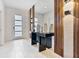 Stylish entryway with a decorative mirror, console table, and modern lighting at 8833 Cruden Bay Ct, Davenport, FL 33896