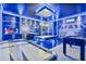 Large game room features Star Wars theme, including multiple games and sleek lighting at 8833 Cruden Bay Ct, Davenport, FL 33896