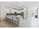 Modern kitchen with a large island, stainless steel appliances, and white cabinetry at 8833 Cruden Bay Ct, Davenport, FL 33896